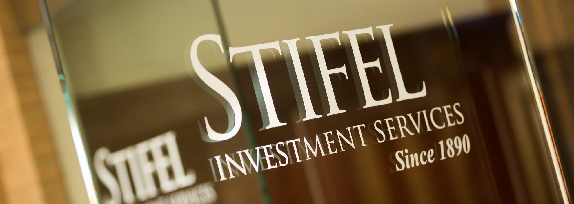 Image of Stifel logo with tagline on glass in Rochester, MI office